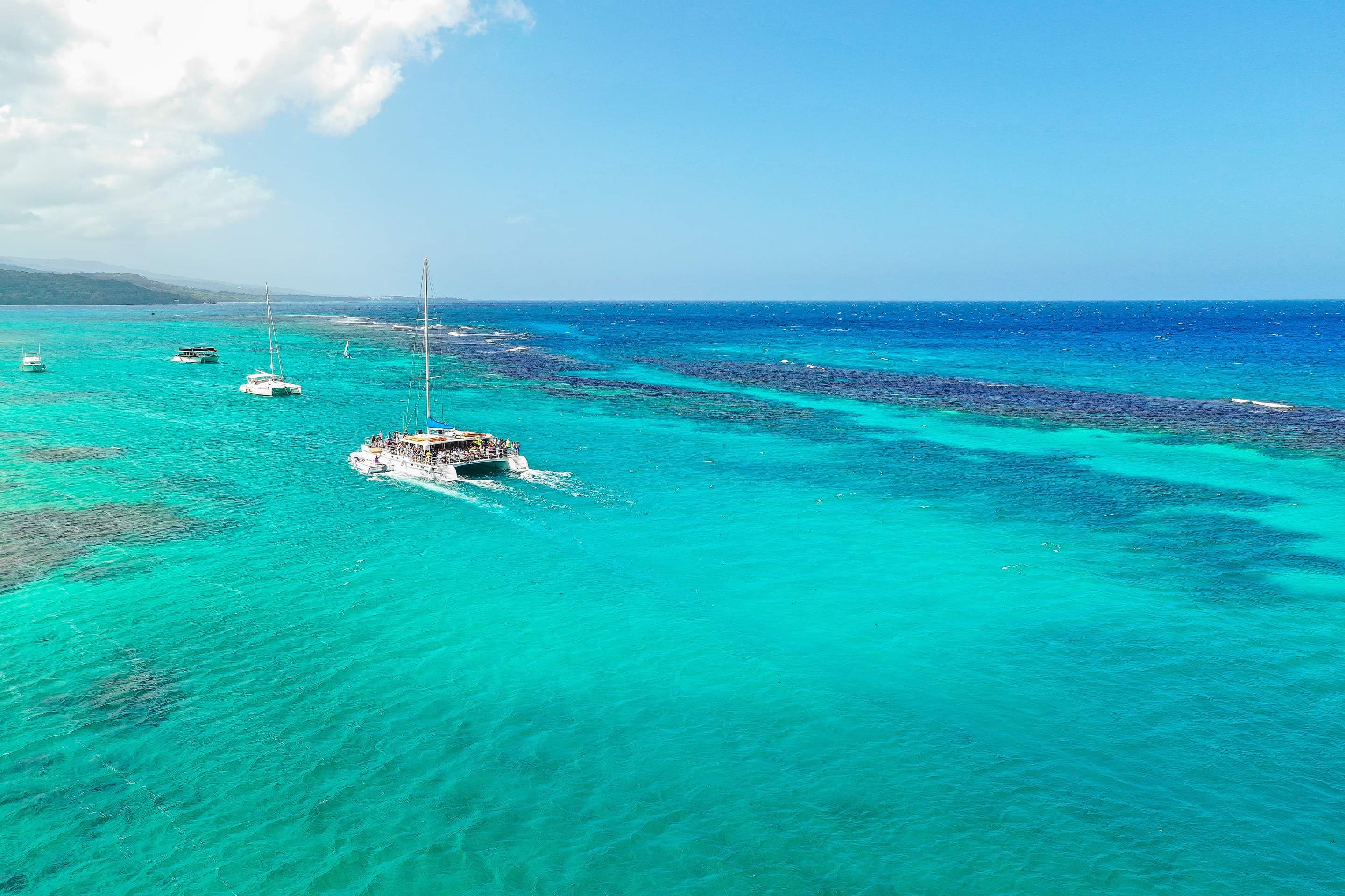 Catamarans anchored over the reef in clear turquoise water